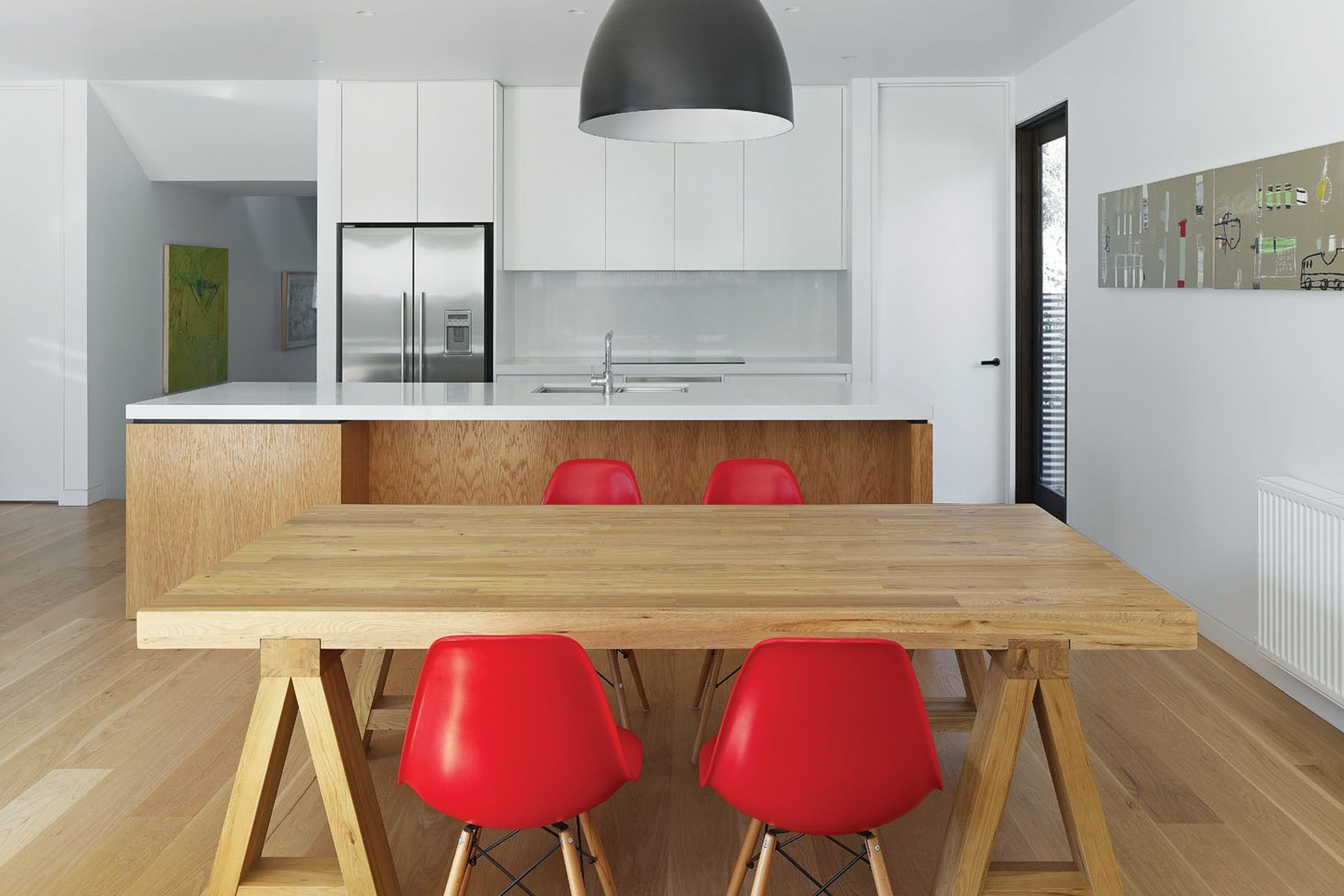 House by the Park kitchen and dining area with oak floor, white joinery, and appliances
