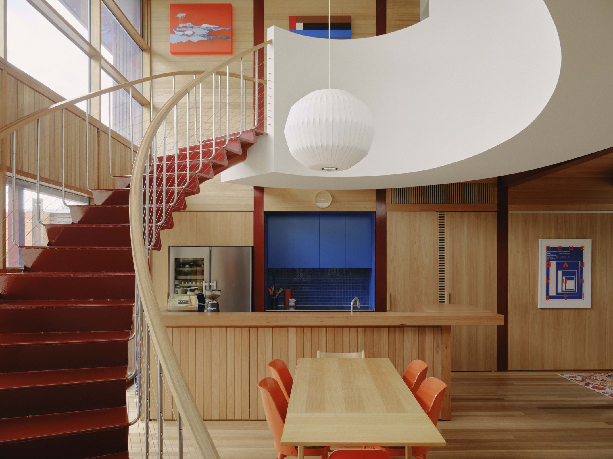 Merri Creek House kitchen with timber joinery, blue tile splashback, appliances, and tapware