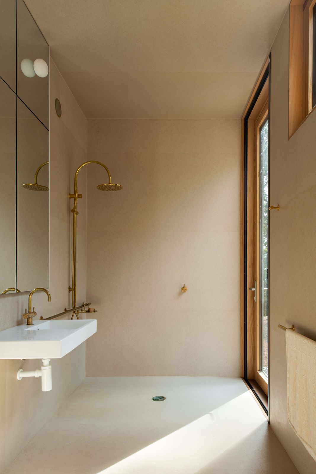 Mountain House bathroom with brass shower, brass basin tapware, basin, and soft flooring